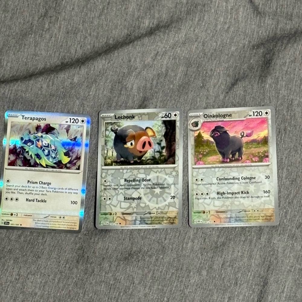 2/$10 Pokemon Trading Cards - Terapagos, Lechonk, and Oinkologne Set
